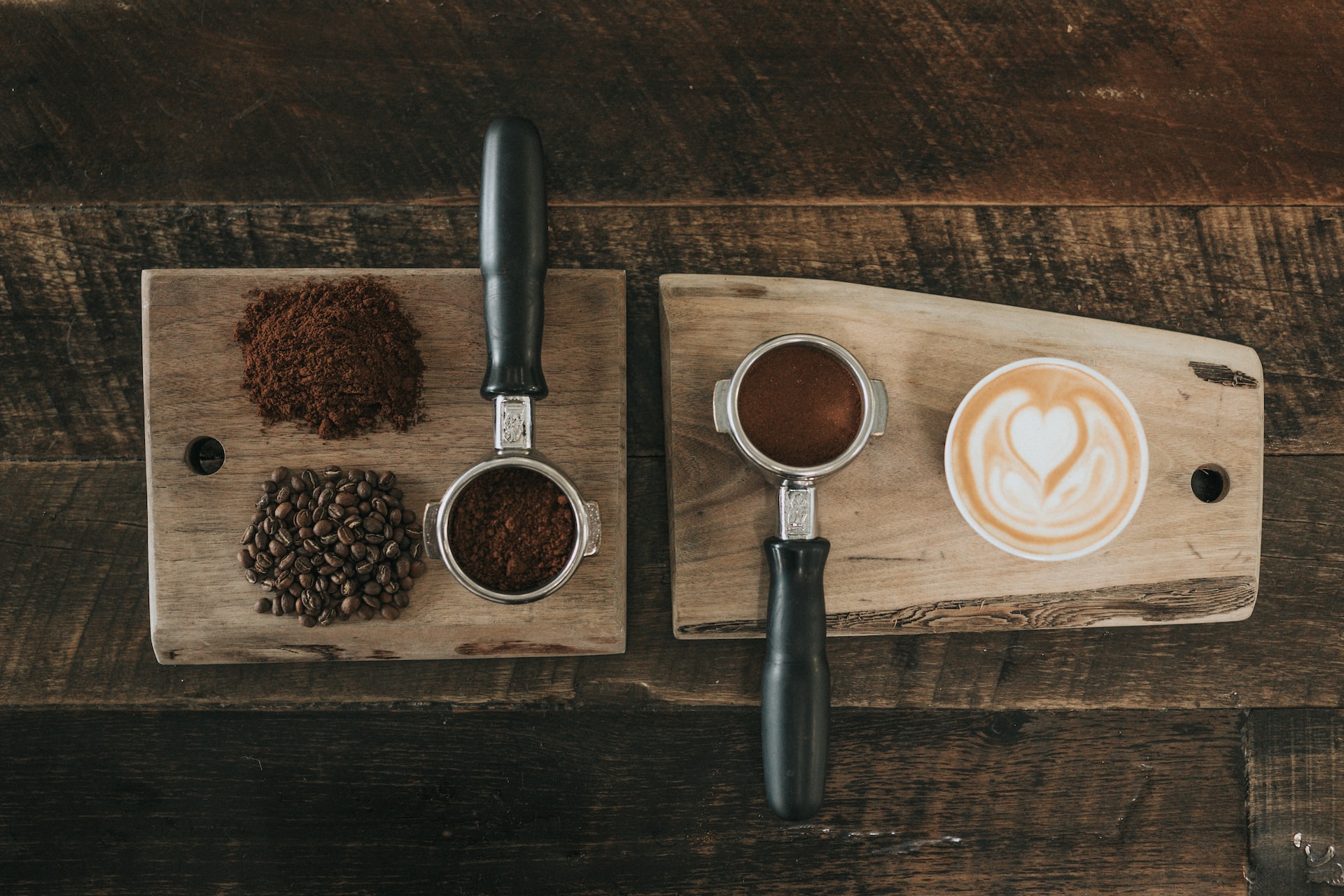 Overhead picture of coffee beans, coffee grounds, and a cappuccino